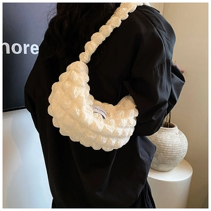Detail of white bubble textured crescent shoulder bag with LOVE FASHION woven label