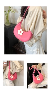 Detailed views of a pink crescent saddle bag featuring a decorative white floral charm