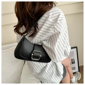 Detailed side view of a black leather hobo shoulder bag with a silver square buckle
