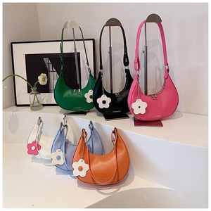Close-up of semi-circle crescent underarm bags with floral charms in six vibrant colors
