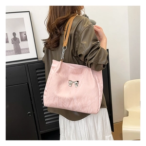 Pink velvet tote bag with metallic butterfly detail and leather chain shoulder strap