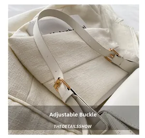 Detail view of the adjustable white Saffiano leather strap and golden buckles on shoulder bag