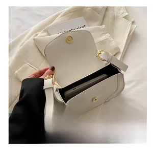 Interior view of off-white leather underarm bag showing spacious storage for a phone