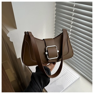 Close-up of a dark brown crescent shoulder bag with a silver buckle and leather strap
