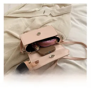Detail showing internal capacity of the pink bow crossbody bag with phone and wallet