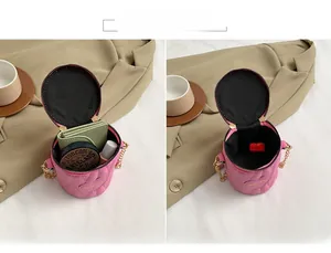 Pink heart quilted cylindrical mini crossbody bag showing internal storage capacity