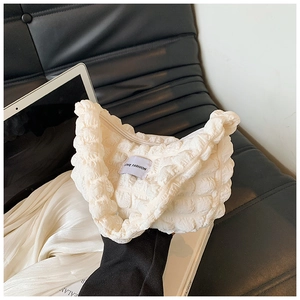 Detail of white bubble cloud bag texture with metal zipper and LOVE FASHION label
