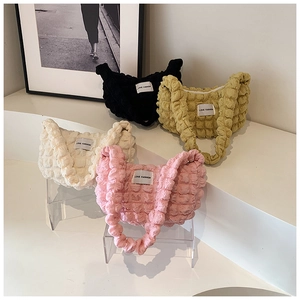 Detailed group view of popcorn texture handbags in black, yellow, beige, and pink colors
