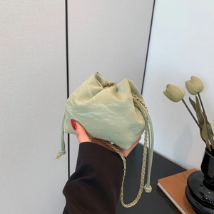 Chic light green bucket bag with chain strap and drawstring closure for women