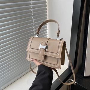 Minimalist beige crossbody small square bag with white wavy stitching and silver buckle