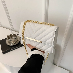 White chevron quilted crossbody bag with gold chain strap and textured finish