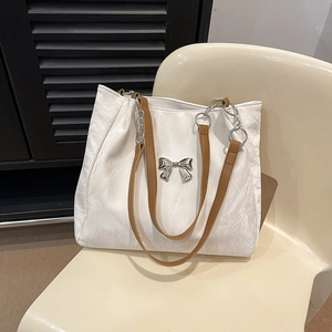 White pleated tote bag with chain strap and silver butterfly accent for daily use