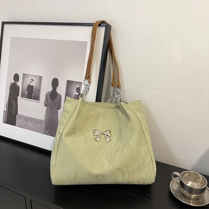 Light green velvet tote bag with butterfly ornament and brown leather chain straps