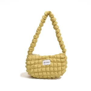 Vibrant yellow bubble textured hobo bag with Love Fashion tag on white background