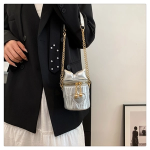 Silver mini bucket bag with bow detail and heart embroidery on metallic V-stitch fabric