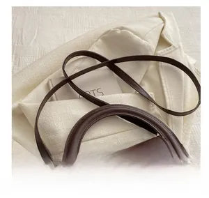 Retro dark brown crossbody bag with circular handle and gold metal hardware detail