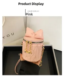 Pink bucket bag featuring heart quilted pattern and decorative 3D bow and chain strap