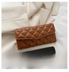 Brown quilted envelope wallet shown next to a smartphone to demonstrate actual size