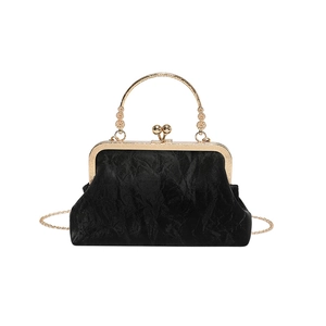 Elegant black velvet vintage clutch bag with gold handle and chain strap for evening events