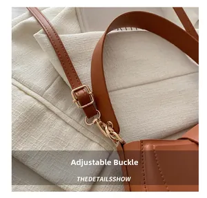 Detail of adjustable brown leather strap with premium gold buckle and metal swivel hook