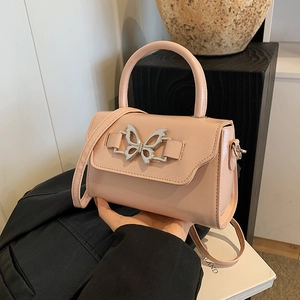 Pink bow handbag with silver butterfly buckle and crossbody strap for summer style