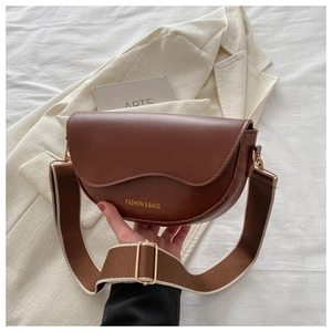 Détail d'un sac besace en cuir PU marron avec large bandoulière et ferrures dorées