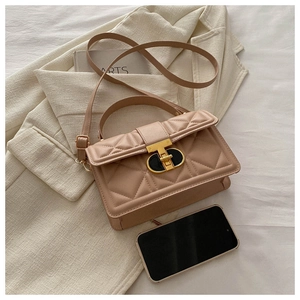 Detailed close-up of beige quilted PU leather crossbody bag with golden metal swivel lock