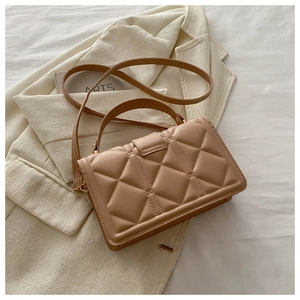 Detailed view of the khaki quilted PU leather bag texture with adjustable strap