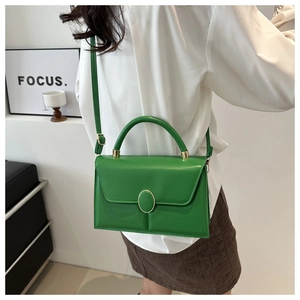 Détail d'un sac bandoulière tendance en PU vert vif avec boucle dorée sur mannequin