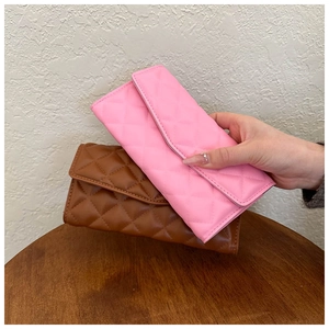 Close-up of pink and brown quilted long wallets made of premium PU leather material