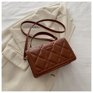Detailed view of dark brown quilted PU leather handbag with elegant gold clasp hardware