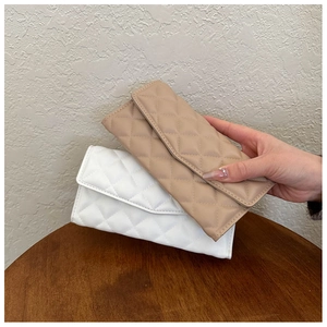 Detailed view of beige and white quilted long wallets with elegant envelope flap design