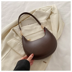Detail of deep brown hobo bag with smooth matte leather and premium gold metal hardware