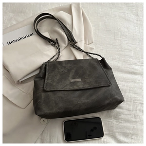 Close-up of vintage grey tote bag with MIKXAIQI logo and metal chain shoulder strap