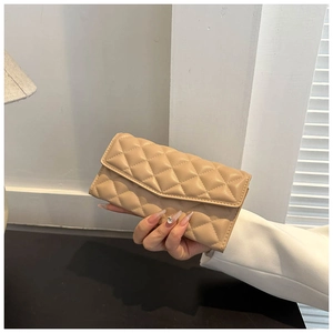 Detailed view of beige quilted long wallet with envelope flap design in hand