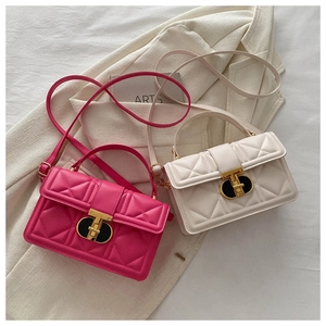 Close-up of quilted PU leather crossbody bags with gold twist lock and elegant texture