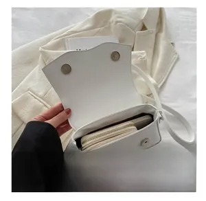 Interior view of white crossbody bag showing capacity for wallet and smartphone
