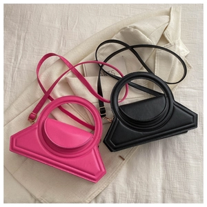 Detail of fuchsia and black trapezoid purses with circular handles and thin shoulder straps