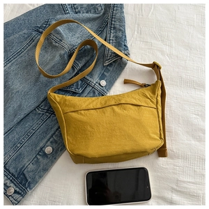 Detail of ginger yellow nylon half-moon crossbody bag with adjustable wide strap