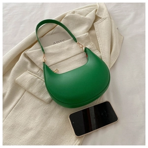 Close-up of green crescent underarm bag with gold metal buckles and zipper detail