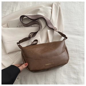 Close-up of retro brown PU leather hobo bag with adjustable geometric wide strap