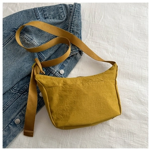 Macro shot of ginger yellow crescent crossbody bag made of water-resistant nylon fabric