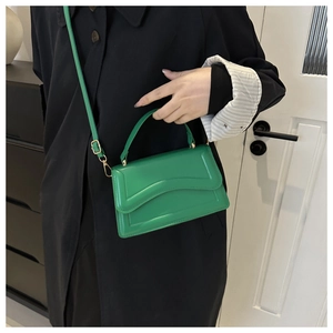 Chic emerald green flap handbag with top handle and crossbody strap for women