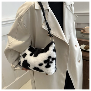 Detail of the soft faux fur plush texture with stylish black and white cow print pattern