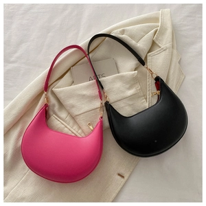 Detailed top view of minimalist peach pink and black PU leather underarm bags with gold zippers