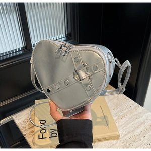 Silver heart-shaped crossbody bag with metallic PU finish and rivet strap details