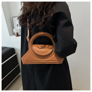 Brown geometric leather handbag shown on model side-back view with slim shoulder strap