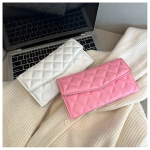 Detail of pink and white quilted leather envelope wallets on a knit sweater background