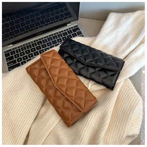Detail shot of quilted pattern flap wallets in black and brown on white knit fabric