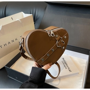 Brown heart-shaped PU leather crossbody bag with silver studs and metal buckle detail